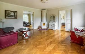 a living room with a wood floor and a fireplace at Nice Apartment In Mullsjö With Sauna in Mullsjö