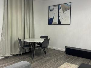 a table and chairs in a room with a picture on the wall at SmartFix Luxury Properties in Lagos
