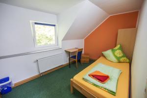 シュトルベルクにあるHotel Burghofのベッドと窓が備わる小さな客室です。