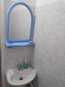 a bathroom with a sink and a mirror on the wall at Athina Rooms in Shënvasi +31 photos