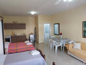 a kitchen and a living room with a table and a couch at Athina Rooms in Shënvasi