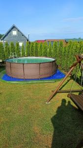a swimming pool in a yard with afficient sqorsenalsenalsenalsenalsenalsenal at Domki Tabaluga in Rusinowo