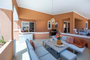 a living room with couches and a table at DeCaNa Prestige Apartment - Gated Community Algarve in Porches