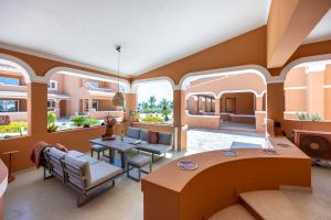 a living room with a table and chairs at DeCaNa Prestige Apartment - Gated Community Algarve in Porches