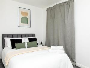 a bedroom with a large white bed and a window at Manchester 2Bedroom Near Etihad Stadium & Coop Live Arena in Manchester