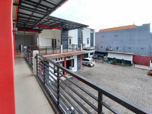 a balcony of a building with a parking lot at RedDoorz Syariah at Homestay Bougenville near Taman Alun-Alun Kota Lamongan in Lamongan