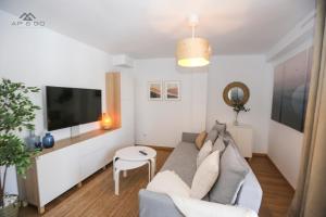a living room with a couch and a tv at Fuerte Luxury Penthouse & Jacuzzi in La Herradura