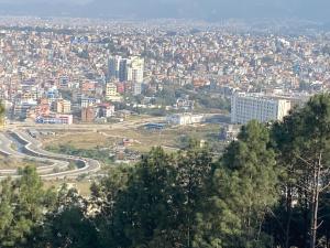 a view of a city with buildings and trees at Kathmandu Family Home in Kirtipur