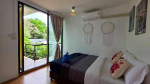 a bedroom with a bed and a large window at The Park Ayutthaya Resort And Spa in Phra Nakhon Si Ayutthaya