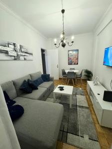 a living room with a couch and a table at Modern 2BR Apartment with City Views I Near Lisbon by LivinInLisboa in Queluz