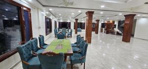 a conference room with a long table and chairs at The Ananta Palampur in Pālampur