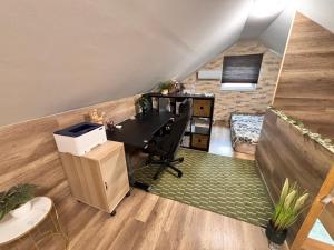 an attic office with a desk and a chair at Csobogó Suites Apartman in Keszthely +73 photos