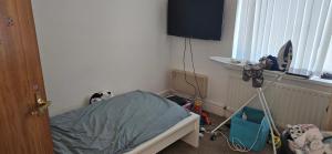 a room with a bed and a television and a camera at Family house in Lemington