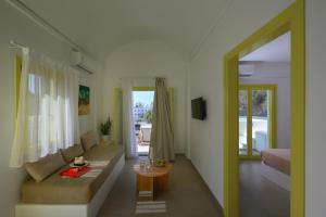 a living room with a couch and a table at New Earth in Kamari