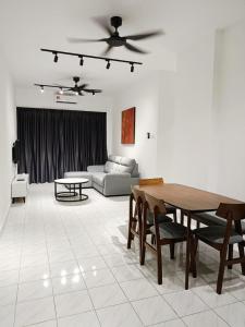 a living room with a table and a couch at Malacca 3 bedroom Seri Serindit G01 in Malacca