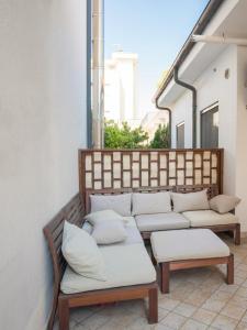 a couch with pillows sitting on a balcony at rapisardi 8 in Riccione