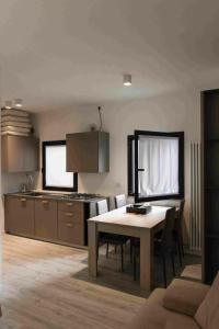 a kitchen and dining room with a table and a counter at rapisardi 8 in Riccione