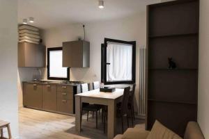 a kitchen with a table and a kitchen with a dining room at rapisardi 8 in Riccione +5 photos