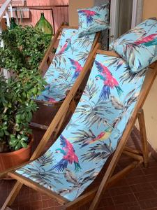 a couple of bunk beds with colorful birds on them at The Riviera Apartment in Lavagna