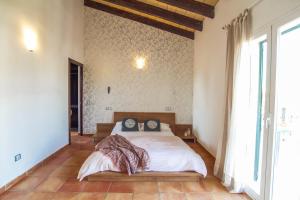 a bedroom with a bed and a large window at Villa Petit Lujo in Badia Gran +59 photos