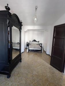 a room with two beds and a mirror at L'Artesania - The Craft village house in Albí