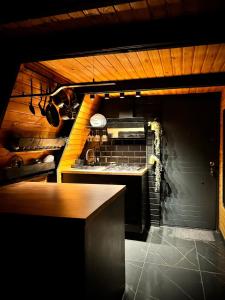 a kitchen with a stove and a counter top at M Cabin A Frame Predeal Ciubar in Predeal +44 photos