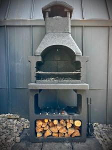 a stone oven with logs inside of it at M Cabin A Frame Predeal Ciubar in Predeal