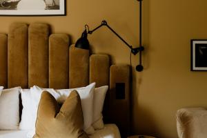 a bedroom with a bed with a lamp and pillows at Quality Hotel Carlia in Uddevalla