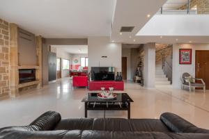a living room with a couch and a table at Arios Lux Villa in Ayía Paraskeví