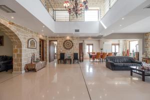 a large living room with a brick wall at Arios Lux Villa in Ayía Paraskeví +38 photos