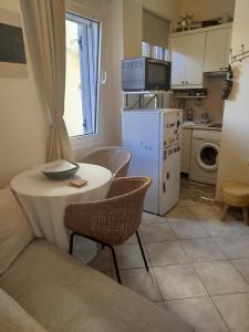 a small kitchen with a table and chairs in a room at Antigoni old town Apartment in Corfu