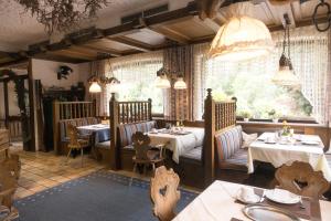 a restaurant with two tables and chairs and a window at Hotel Breitenbacher Hof in Waldachtal