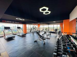 a gym with treadmills and ellipticals in a building at 1BR Marina Bay Westlands with rooftop pool, gym & city views in Nairobi