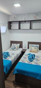 two beds sitting next to each other in a room at Mobile Home Sea Shell Šime, Drage in Drage