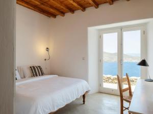 a bedroom with a bed and a view of the ocean at Villa Levi's in Mykonos +86 photos