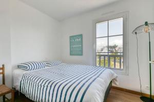 Ein Bett oder Betten in einem Zimmer der Unterkunft Villa Léa Vue mer d'exception Plage