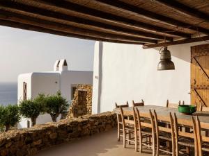 a dining room with a table and chairs at Villa Levi's in Mykonos