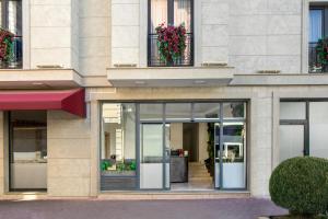 a facade of a building with glass doors and flowers at Lenus Hagia Sophia Hotel in Istanbul