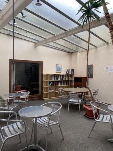 a room with tables and chairs and a palm tree at Hotel Du Commerce in Auxerre