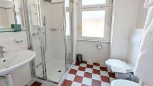 a bathroom with a shower and a sink and a toilet at Residence la Limonera in Bellagio