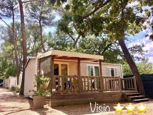 a tiny house with a porch and a deck at ZEcamping 3 étoiles toboggans piscine locatif 25m2 5 pers in Peynier