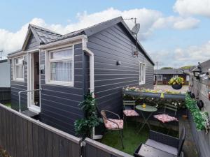 a tiny house with a backyard with a table and chairs at Sandbay in Bridlington