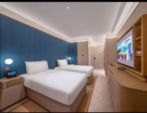 Jingdong Headquarters Crystal Orange Hotel, Yizhuang, Beijing房間的床