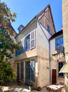 an old building with a table in front of it at L'imparfait - Maison 5 chambres - Home République in Auxerre