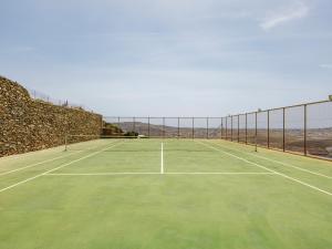 a tennis court with a net on top of it at Villa Levi's in Mykonos