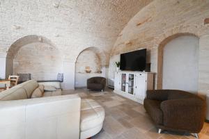 a living room with a couch and a tv at Dimora Zezzella 