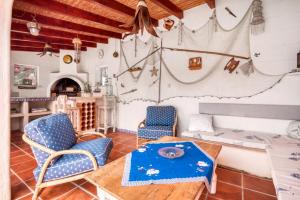 a living room with a table and chairs at Villa Jeannine in El Tosalet