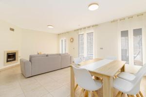 a living room with a table and chairs and a couch at Villa Lavanda in Calpe