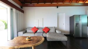 a living room with a couch and a table at Striking Couples Villa Near Toiny Beach in Toiny