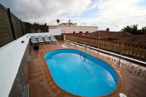 a swimming pool on the side of a building at Villa Santa Rosa Tenerife in Tacoronte